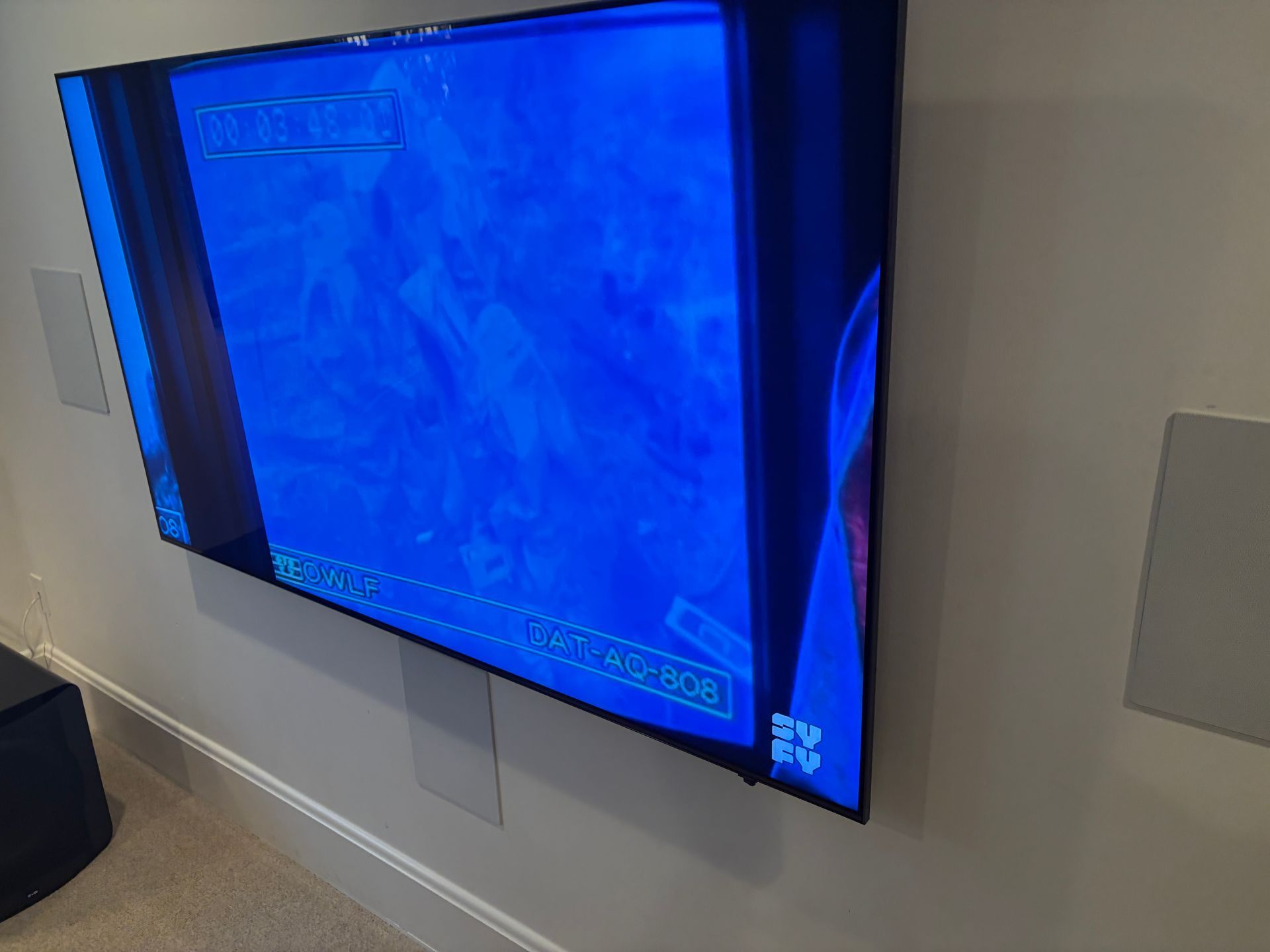 A large flat screen tv is hanging on a wall.