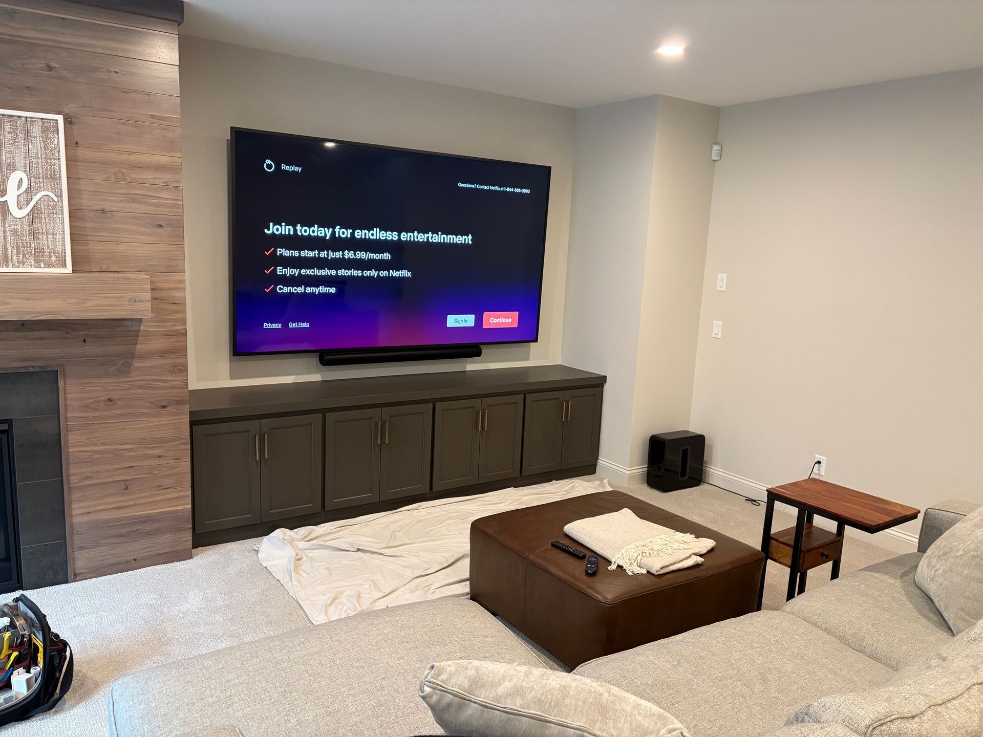 A living room with a large flat screen tv mounted on the wall.