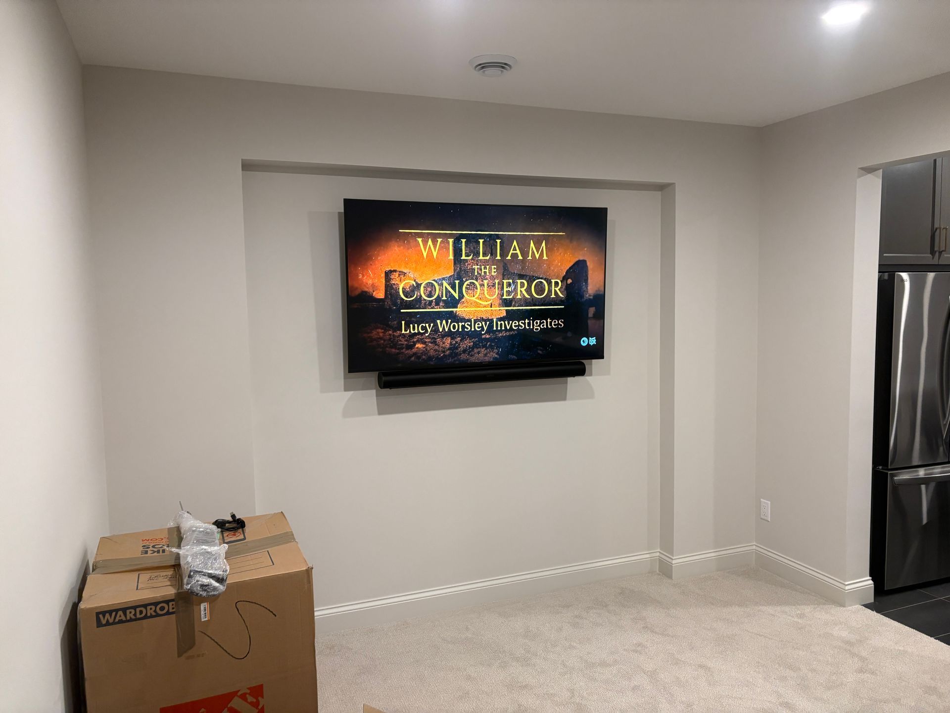 A flat screen tv is mounted on a wall in a room.