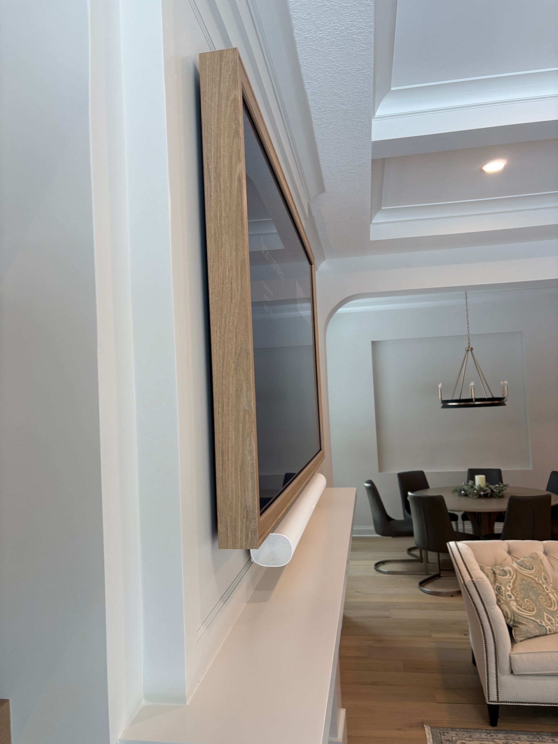 A living room with a flat screen tv mounted on the wall