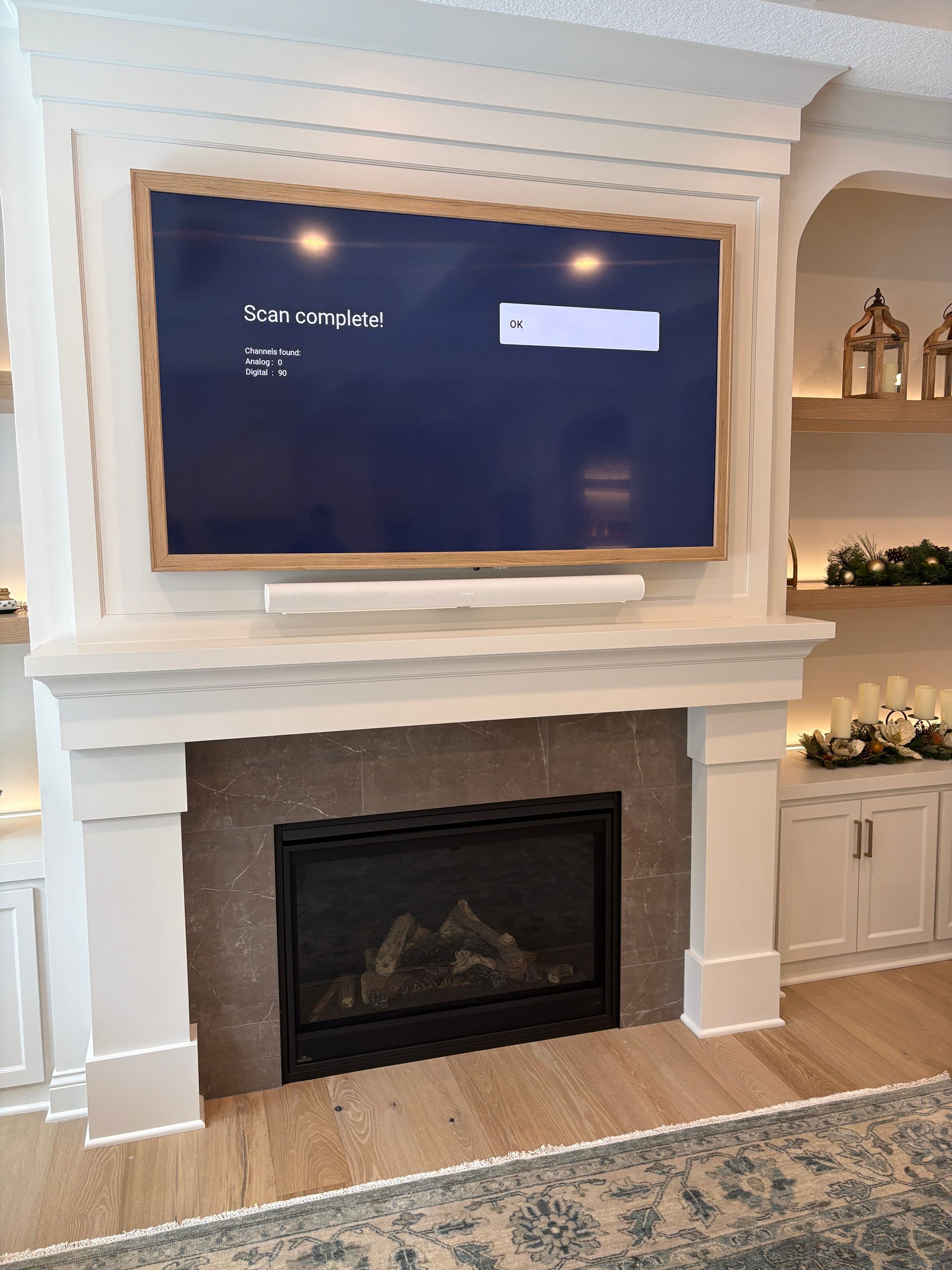 A living room with a fireplace and a flat screen tv