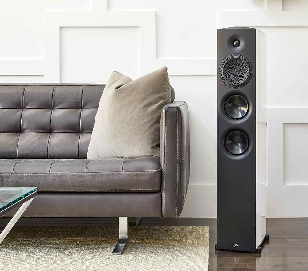 A living room with a couch and a speaker