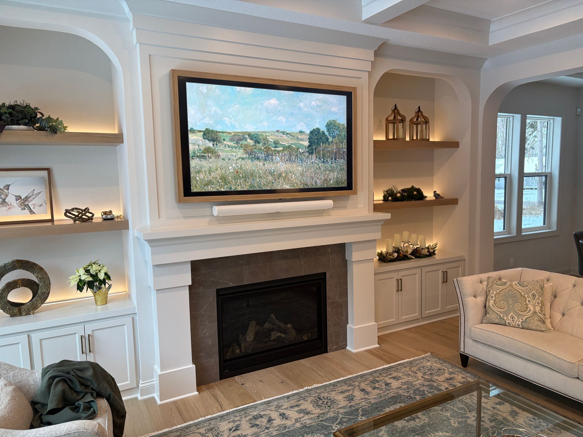 A living room with a fireplace and a flat screen tv above it.