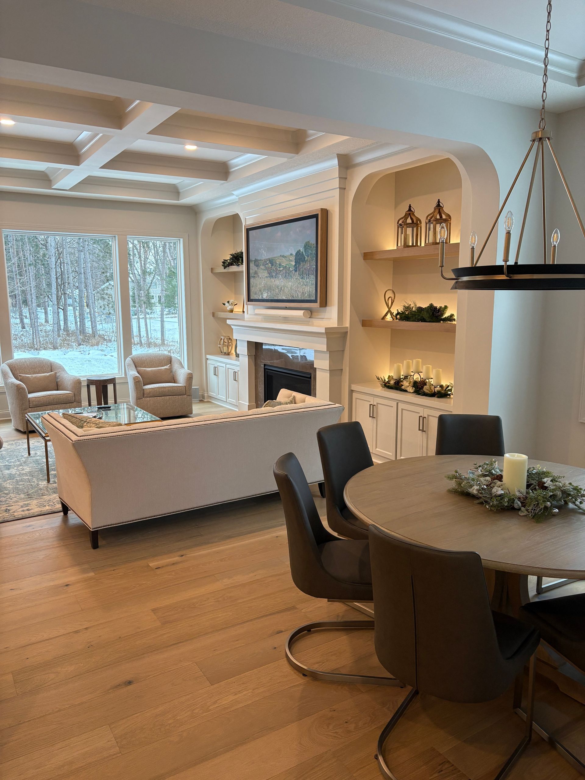 A living room with a dining table and chairs and a fireplace.