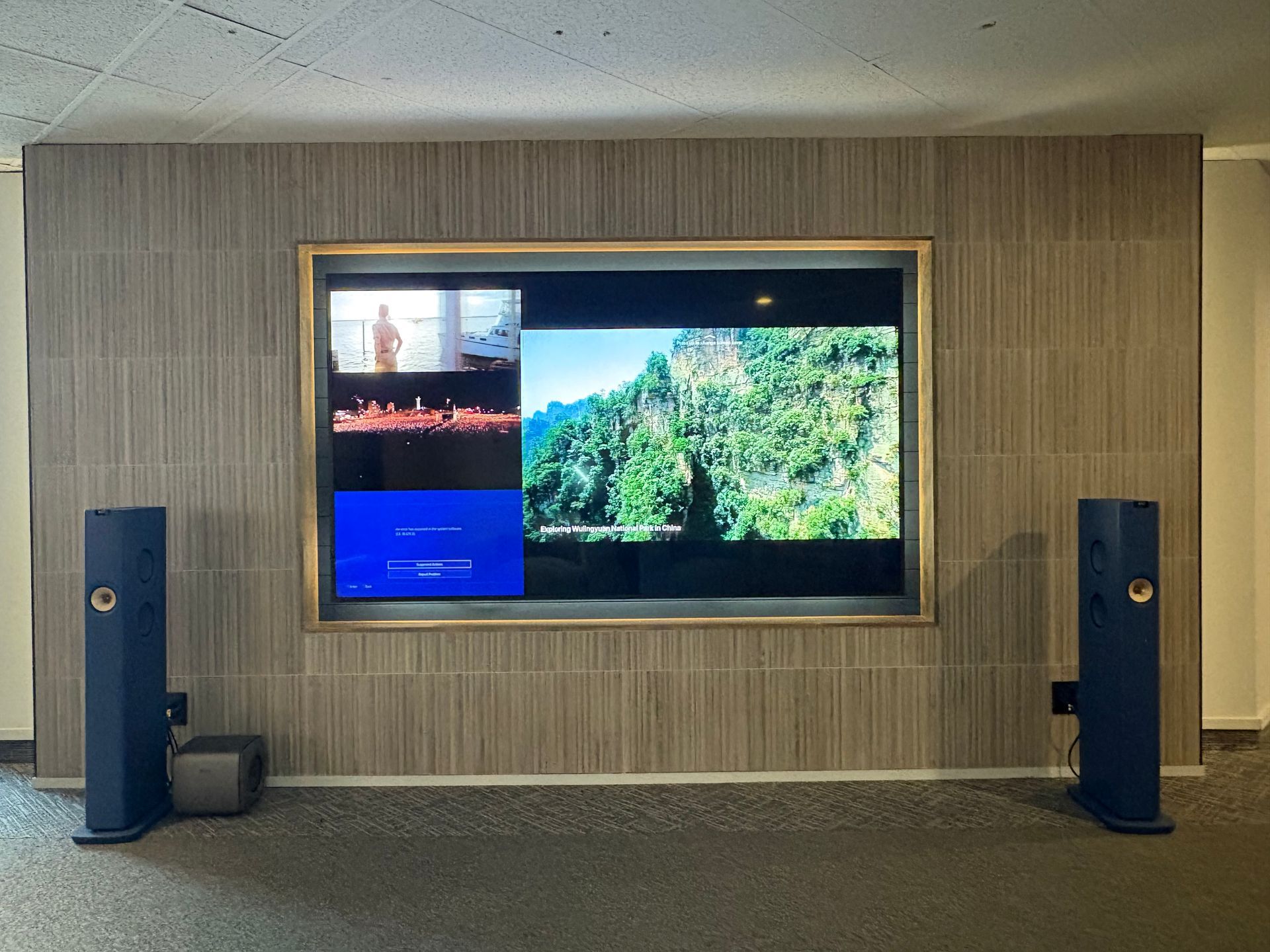 A large flat screen tv is mounted on a wall