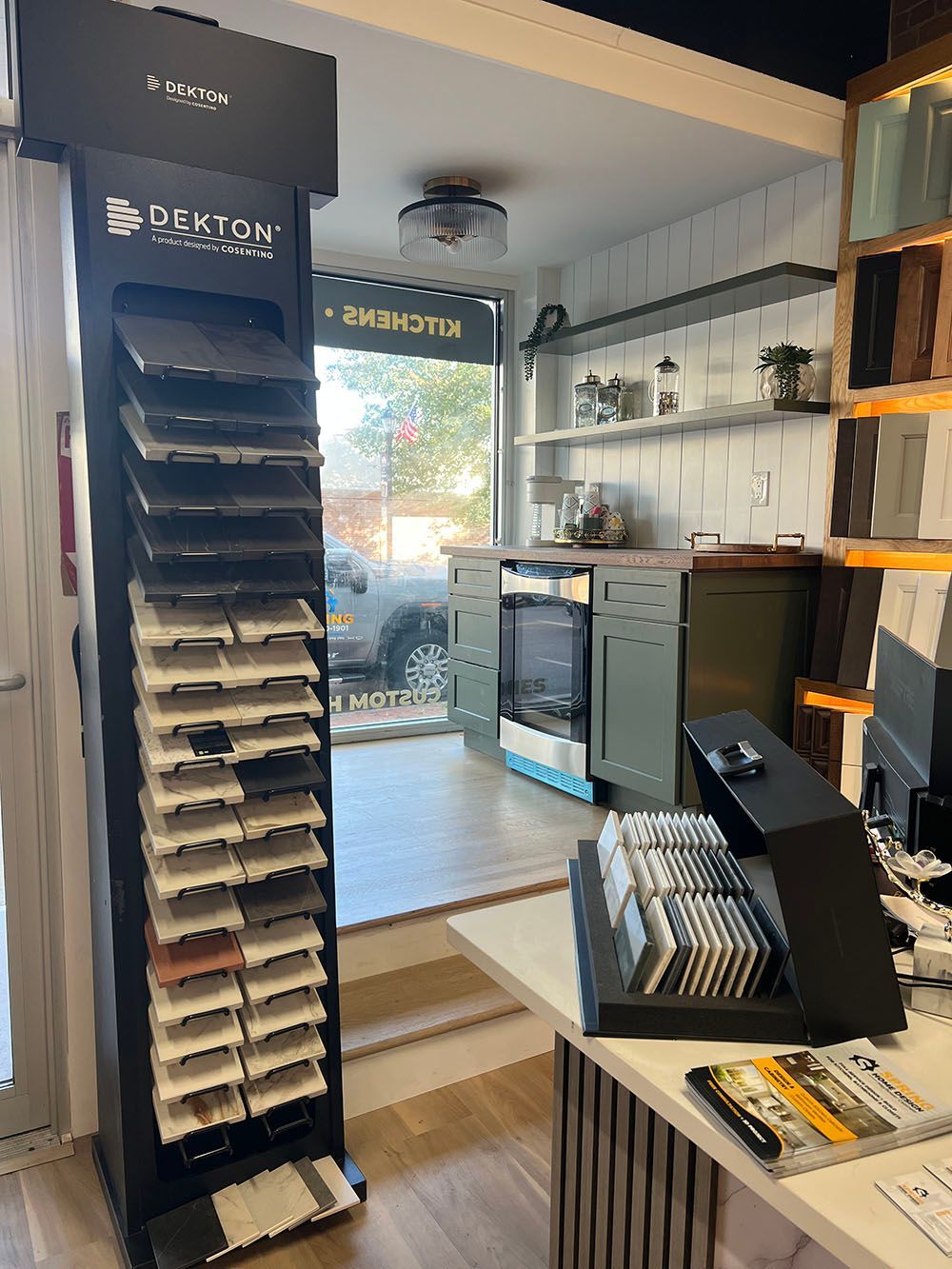 Small retail shop interior with product display racks, shelves, and a counter near the entrance.