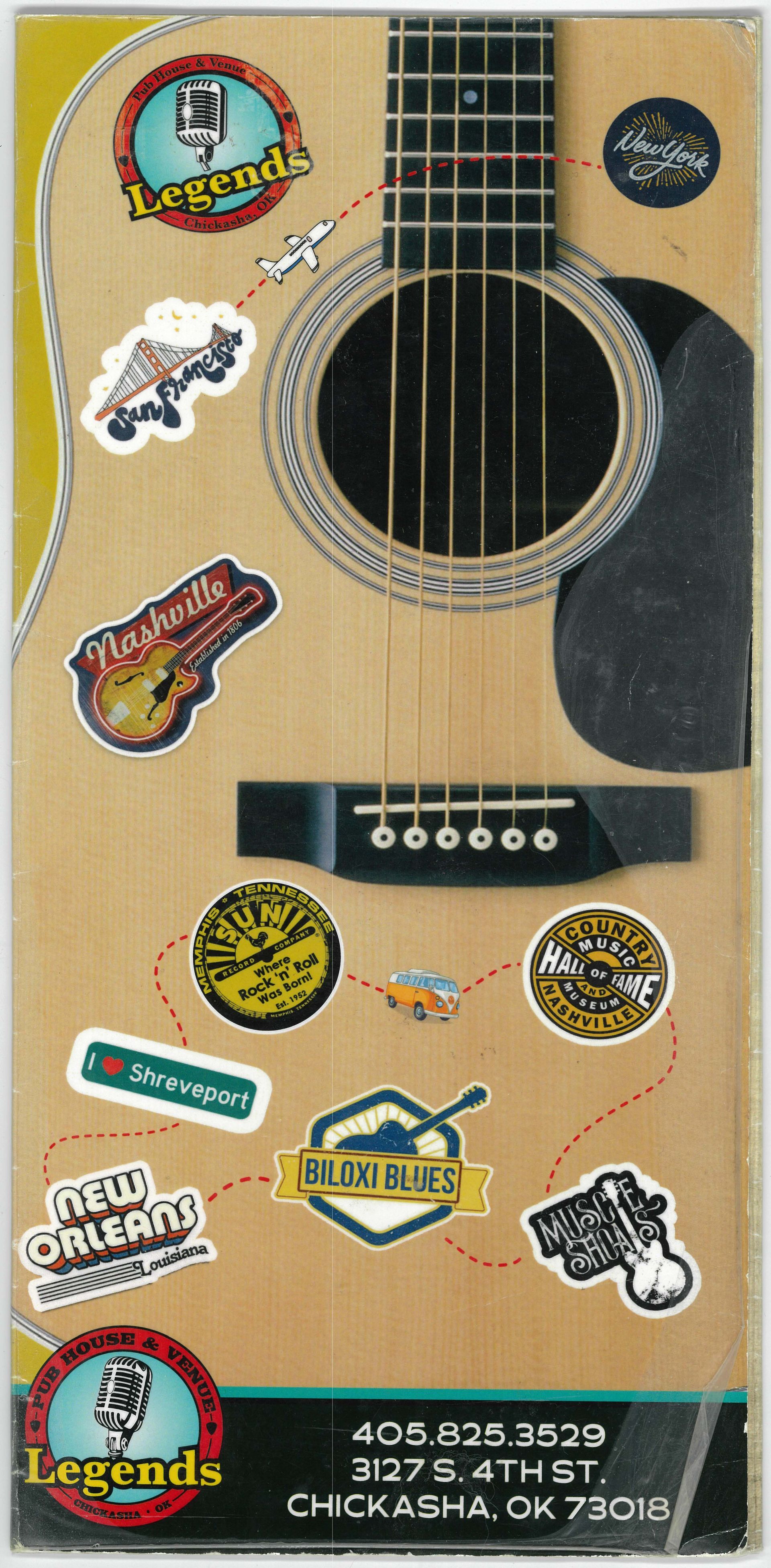 A guitar with many stickers on it including one that says legends
