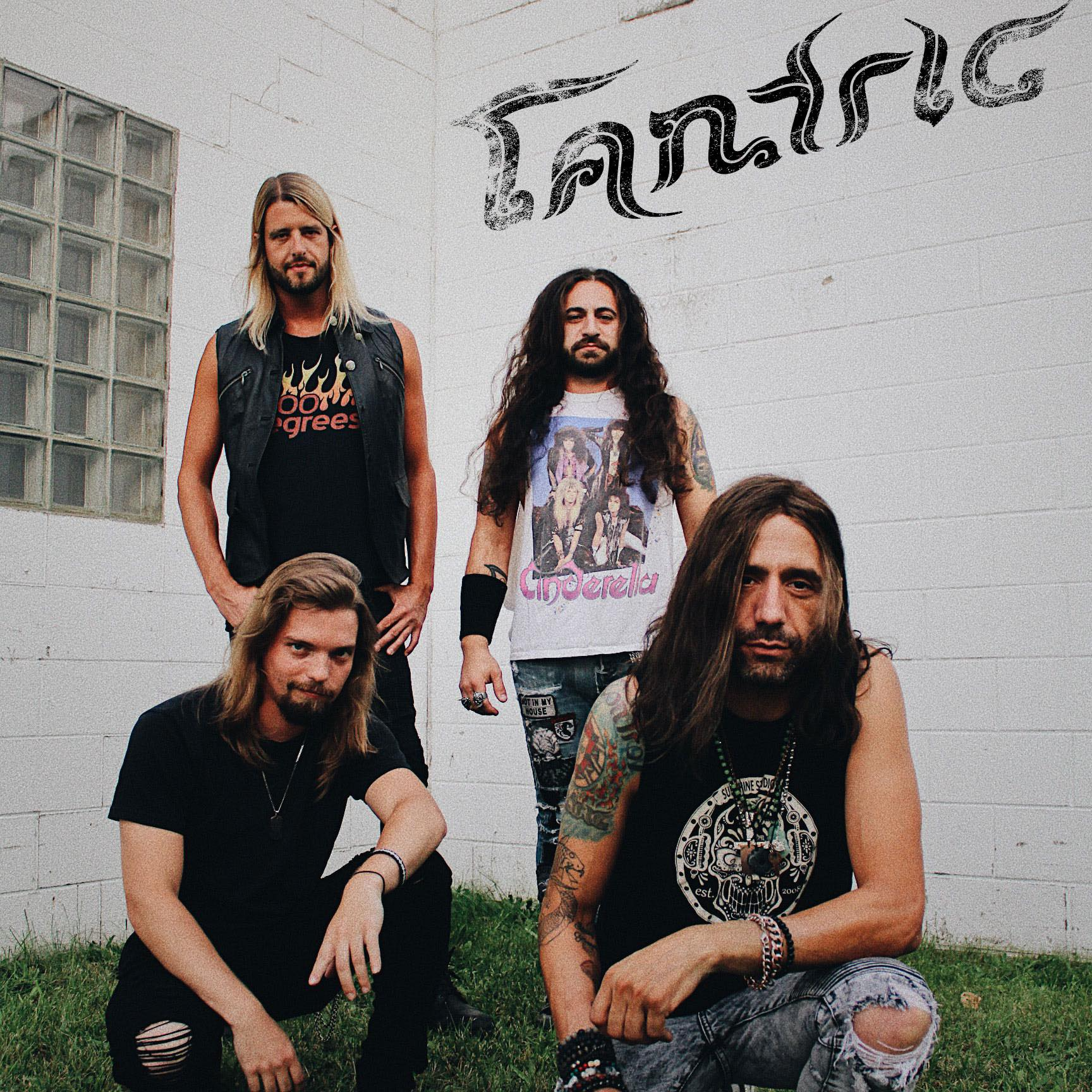 A group of men standing in front of a wall that says tantra