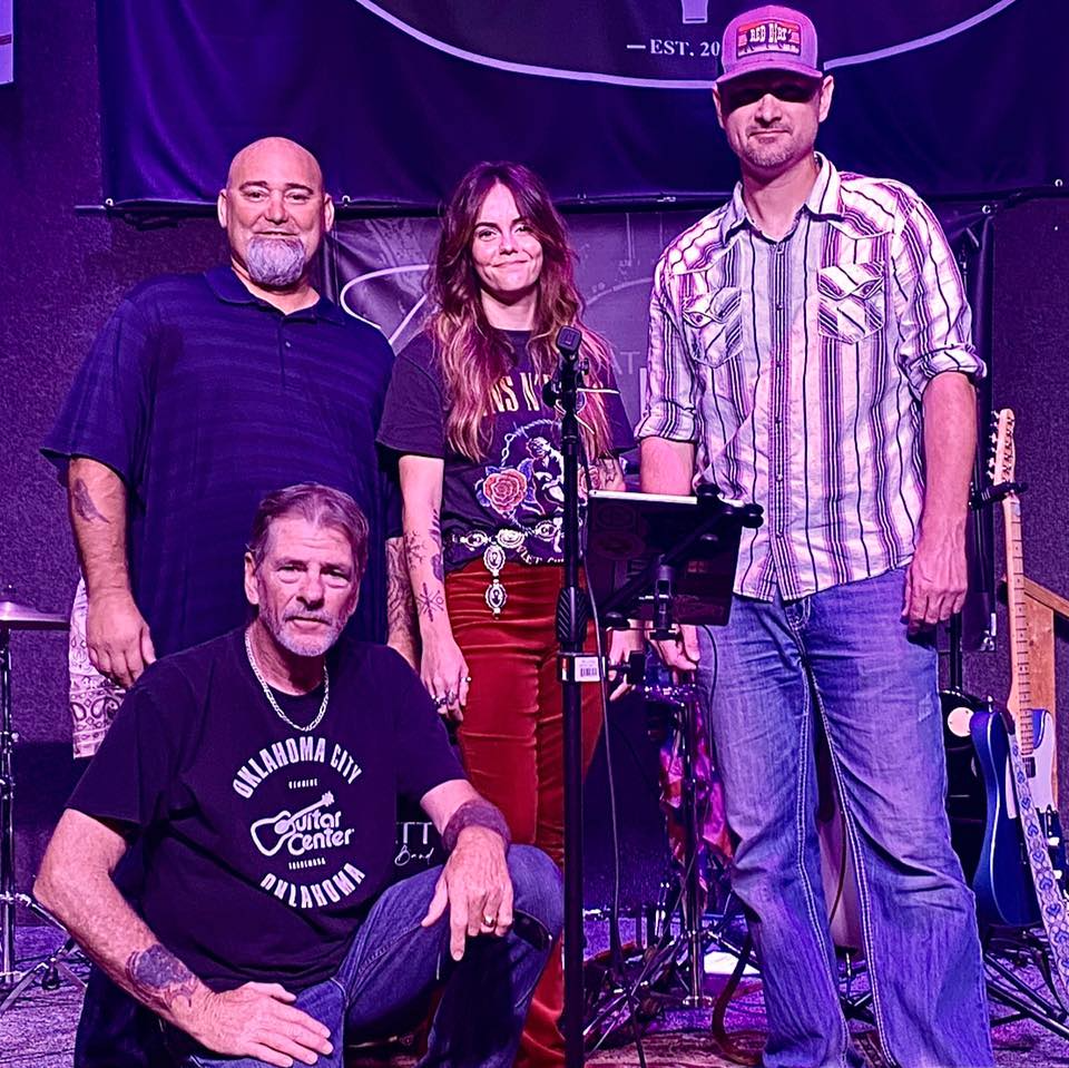 A group of people are posing for a picture on a stage.
