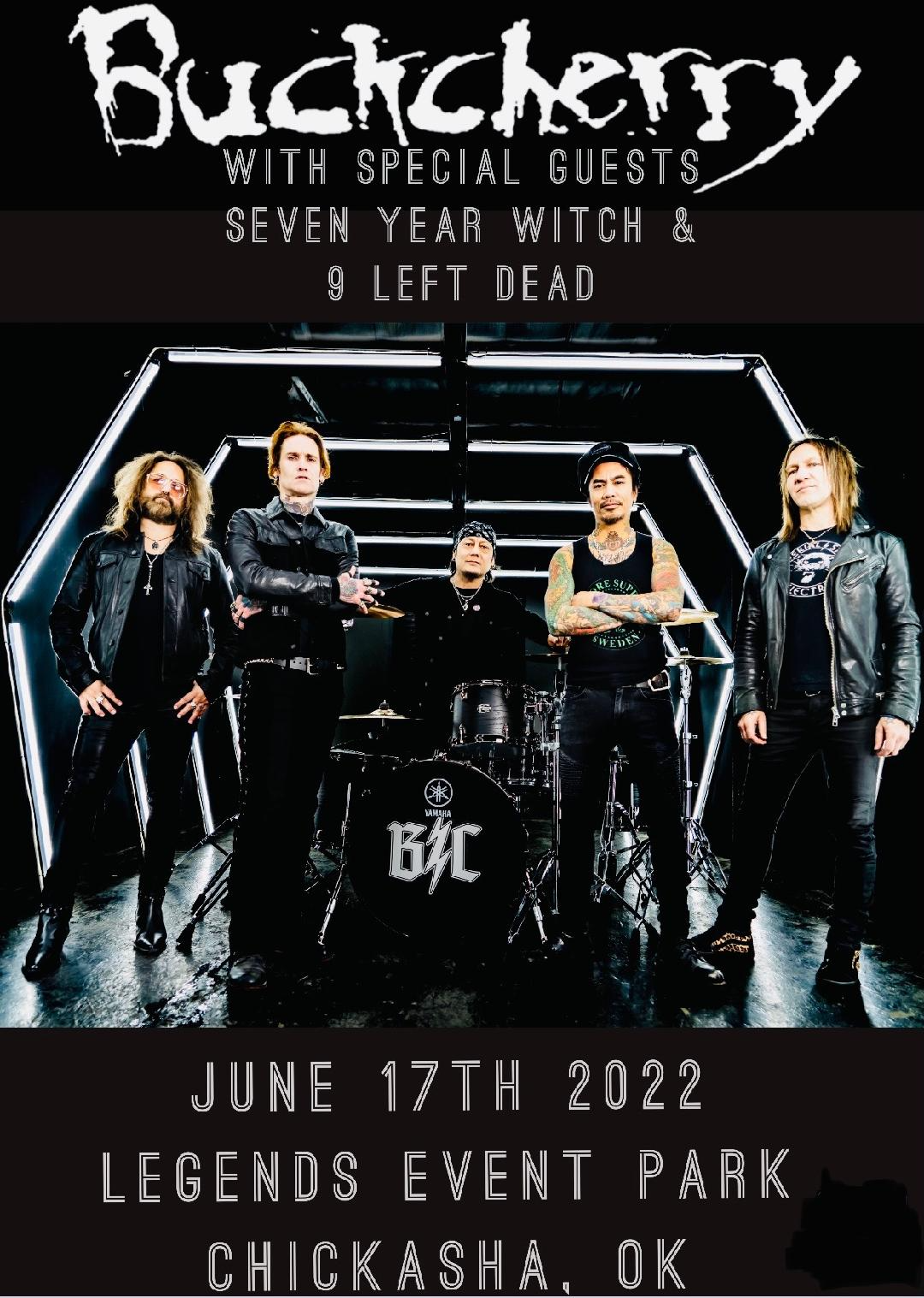Dark background with five band members surrounding a drum set