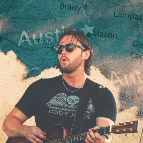 A man wearing sunglasses is playing a guitar in front of a map of austin
