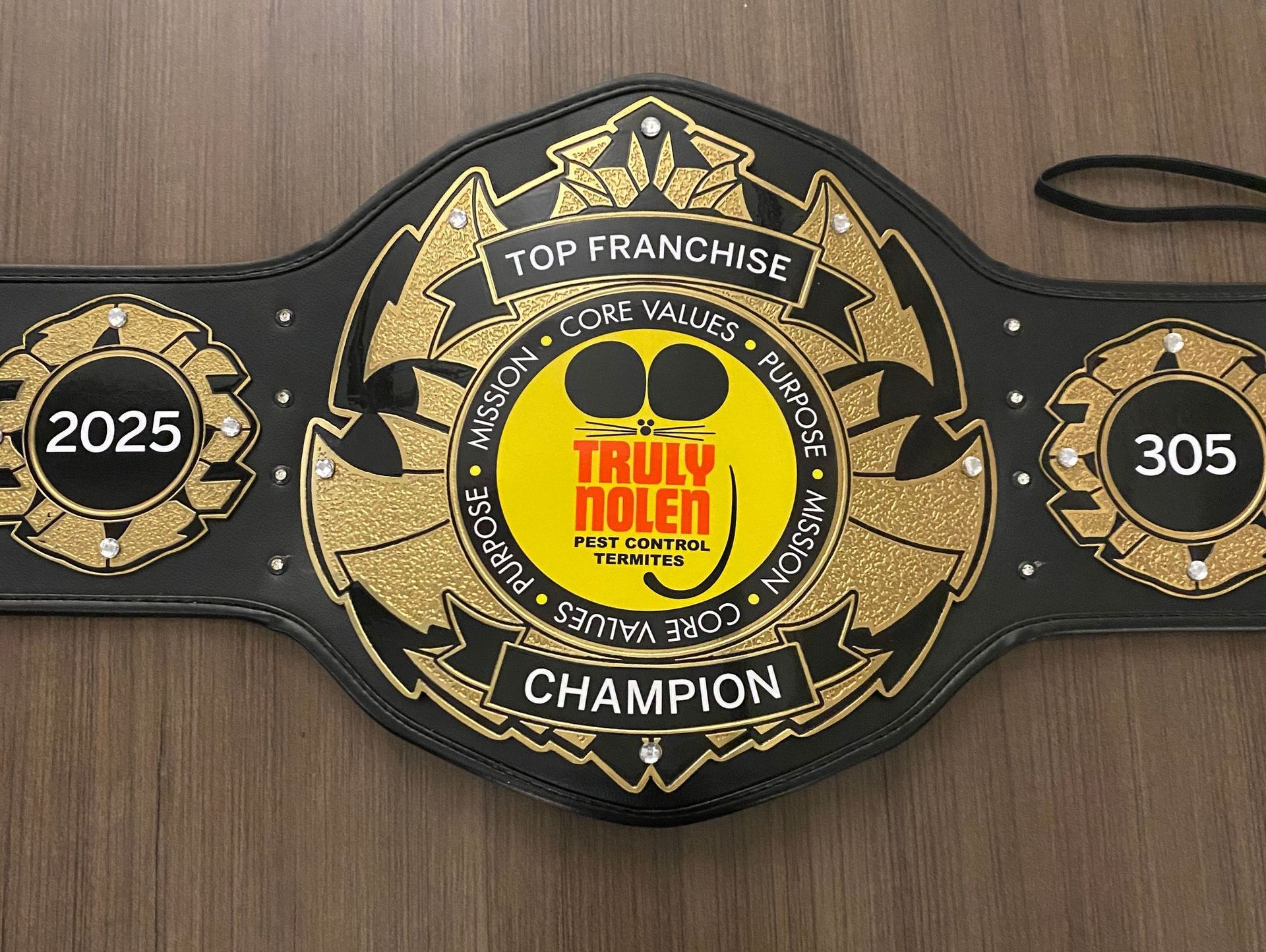 A belt that says ' top franchise ' on it