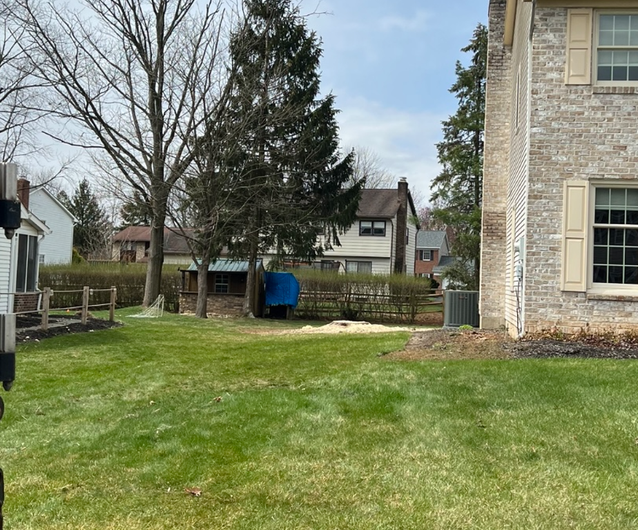 a brick house with a large lawn in front of it