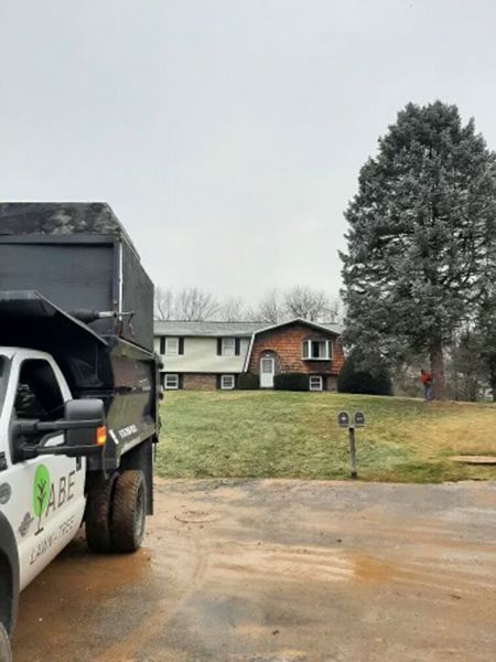 a dump truck is parked in front of a house .
