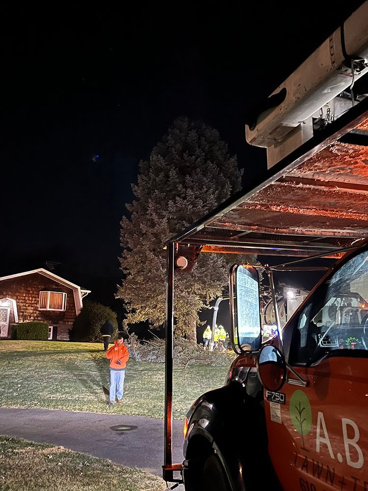 a red truck is parked in front of a house at night 