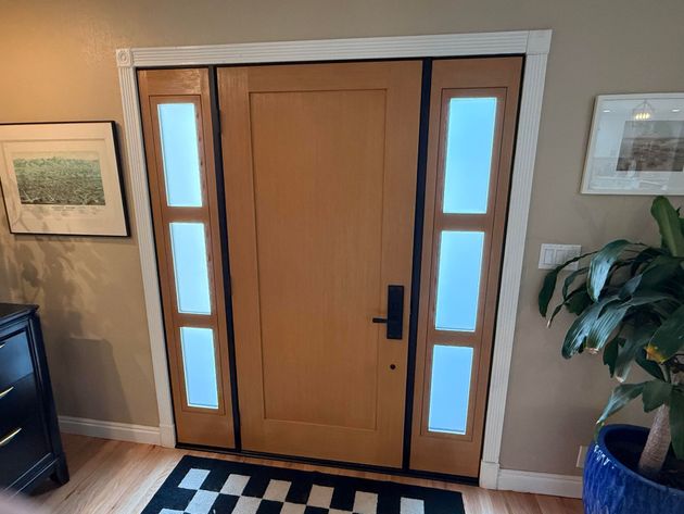 A room with a lot of windows and sliding glass doors.