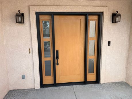 A large wooden door with a black frame