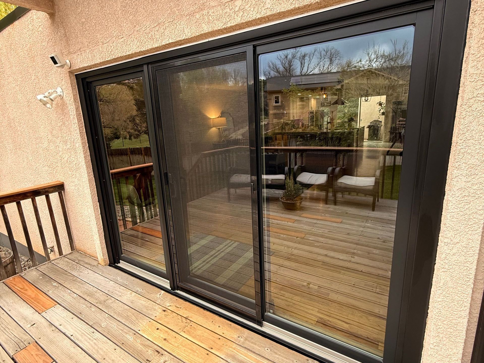 A sliding glass door leading to a deck in a house.