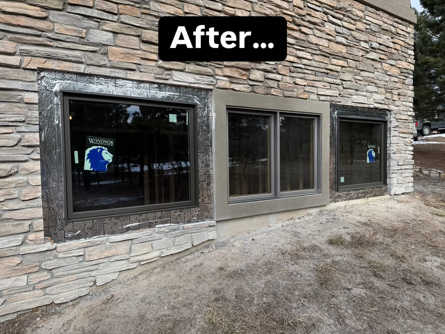 A stone building with three windows and a sign that says after.