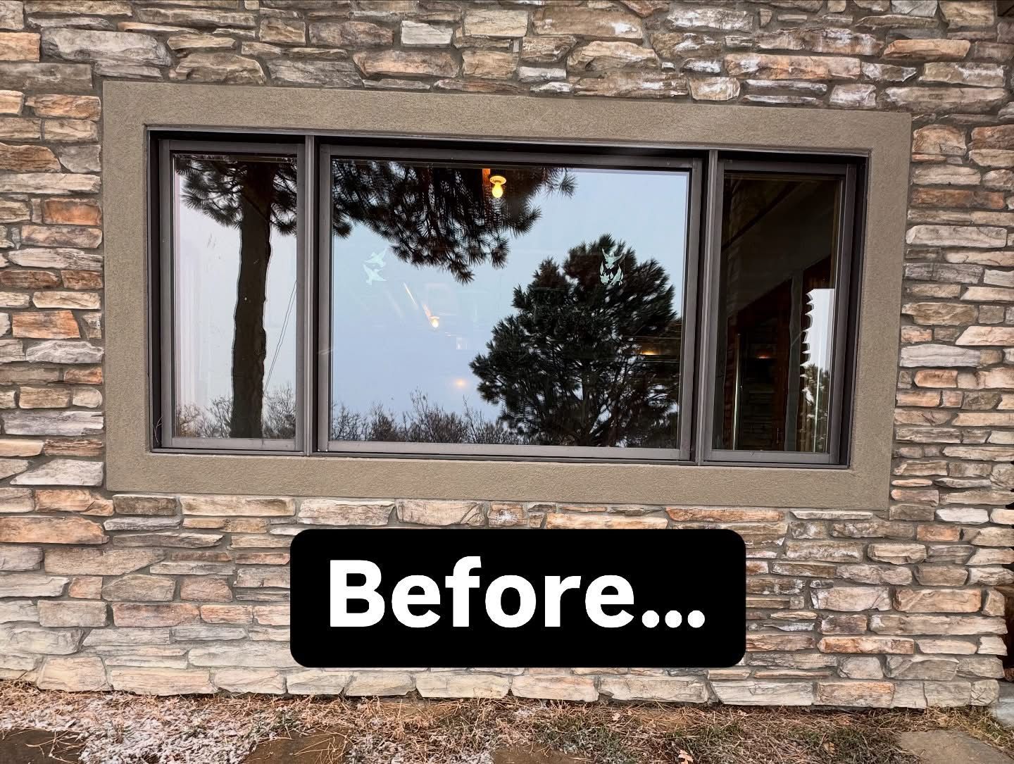 A picture of a window on a stone wall before it was installed