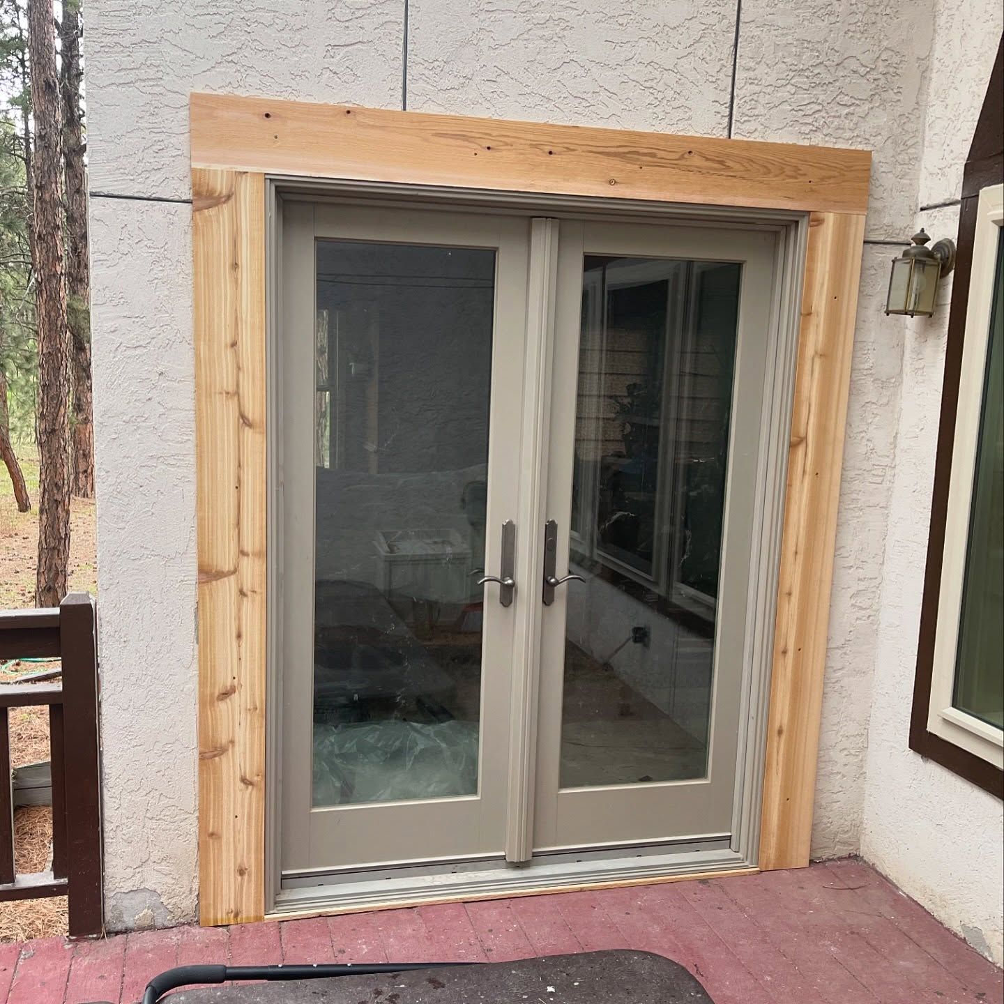 A sliding glass door with a wooden frame