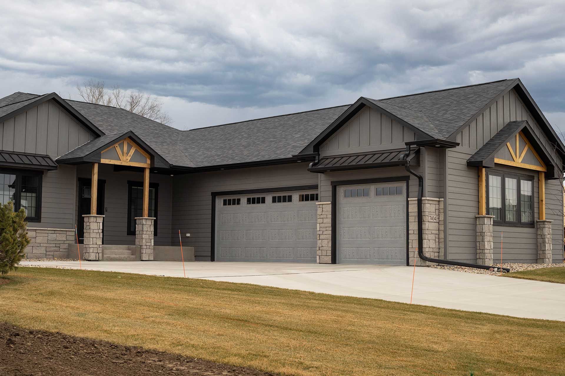 a large house with a gray garage door and a gray roof