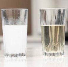 One glass filled with cloudy liquid while the other glass with clear liquid