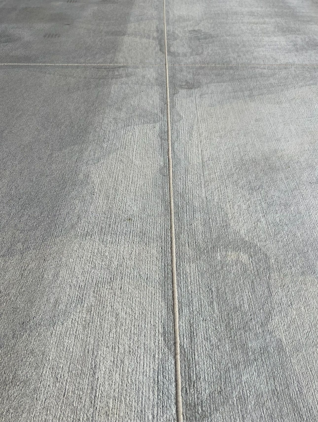 A close up of a concrete floor with a line going through it