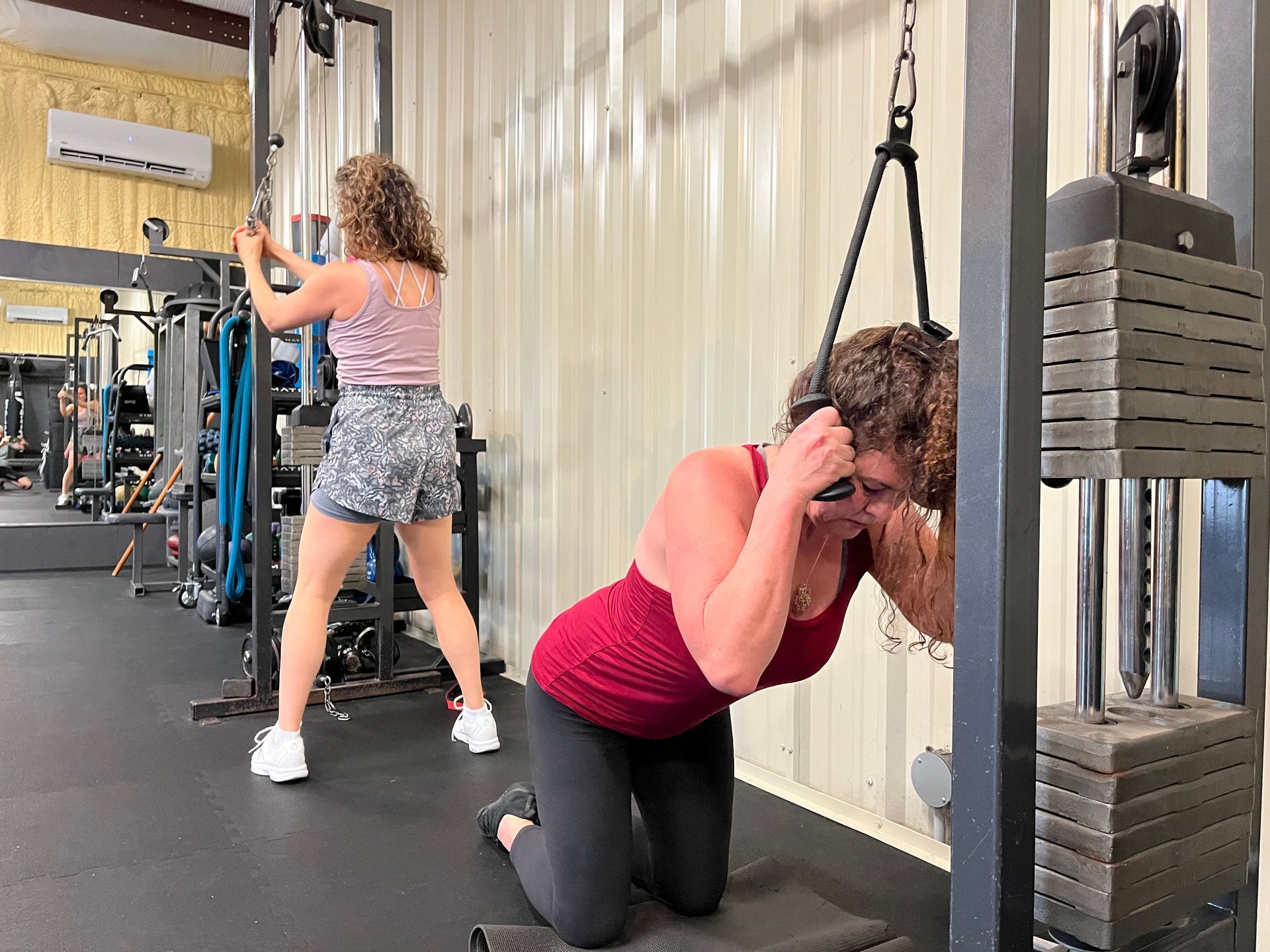 A man is doing sit ups with a medicine ball in a gym