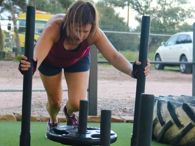 A woman is pushing a sled with a metal plate in the background.