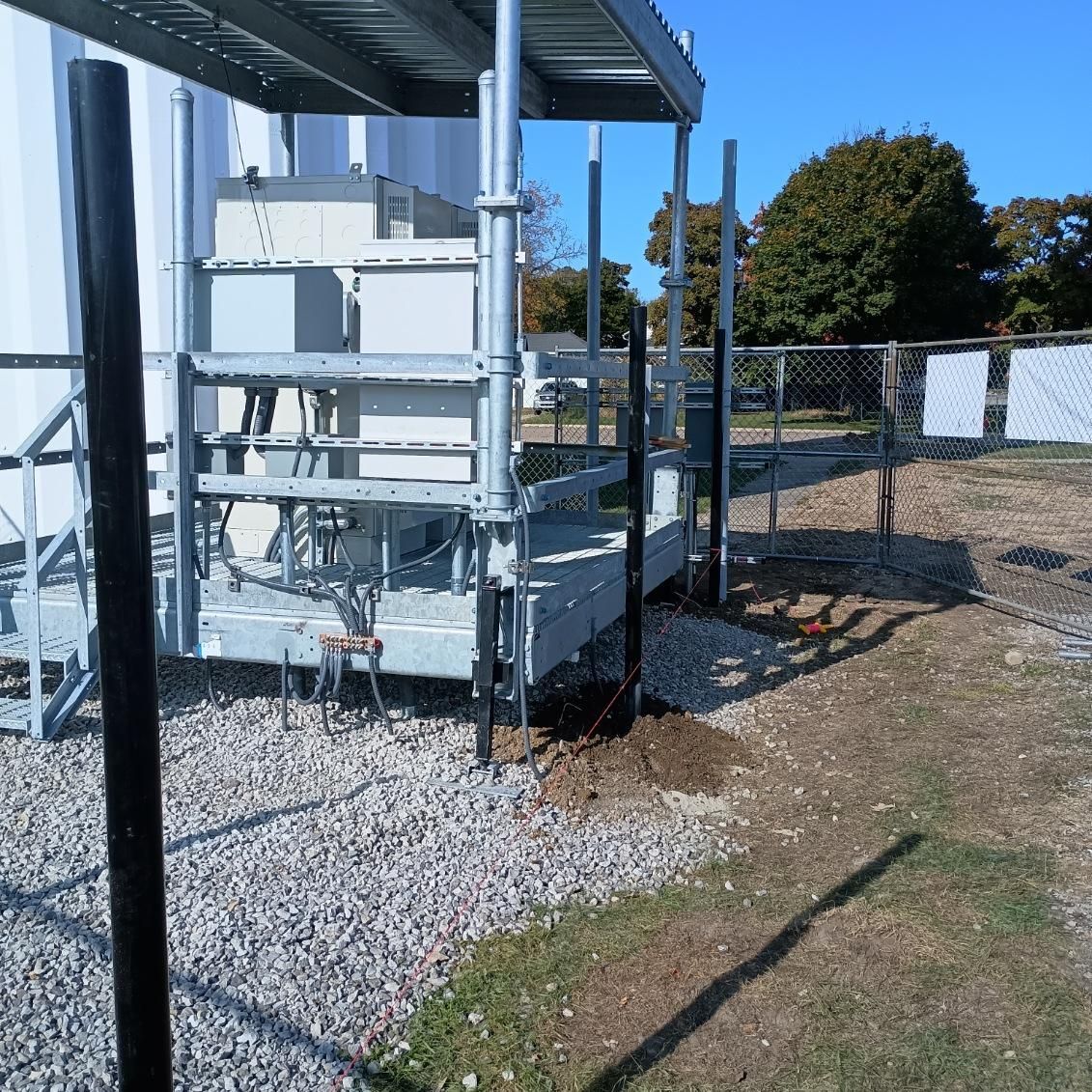 A fenced in area with a metal structure in the background