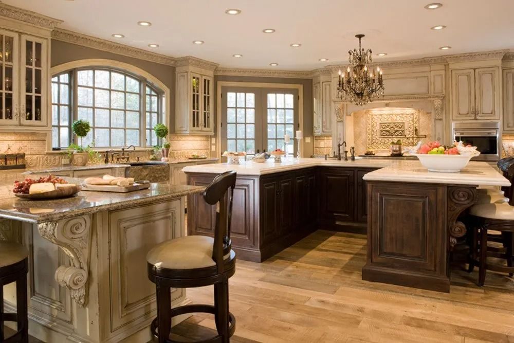 A kitchen with a large island and a chandelier.