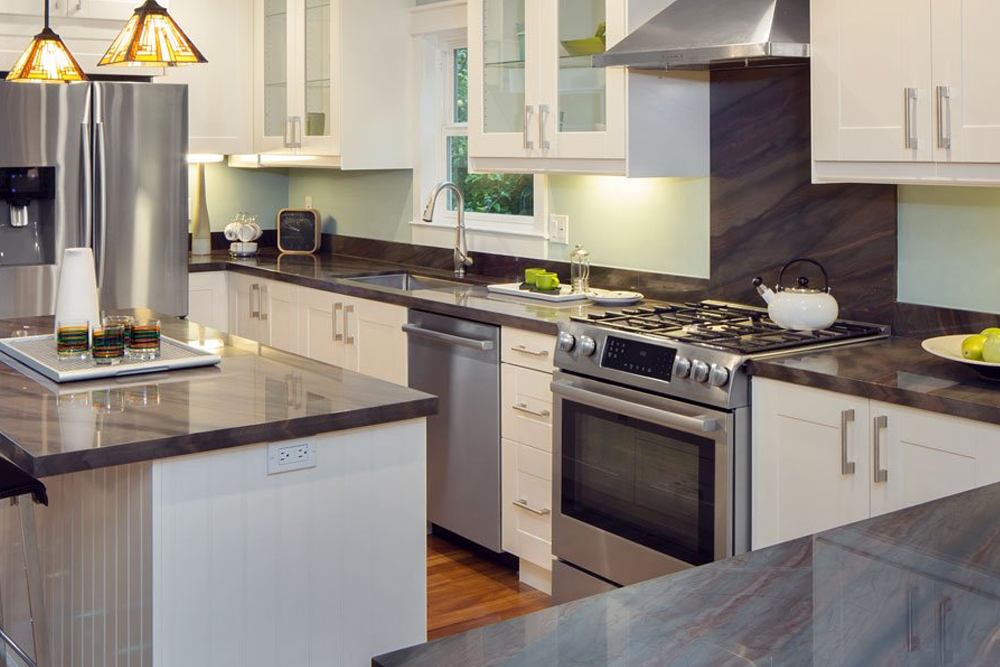A kitchen with stainless steel appliances and white cabinets