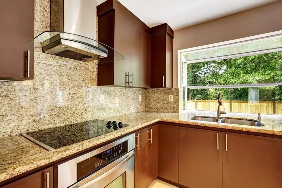 A kitchen with stainless steel appliances and granite counter tops.