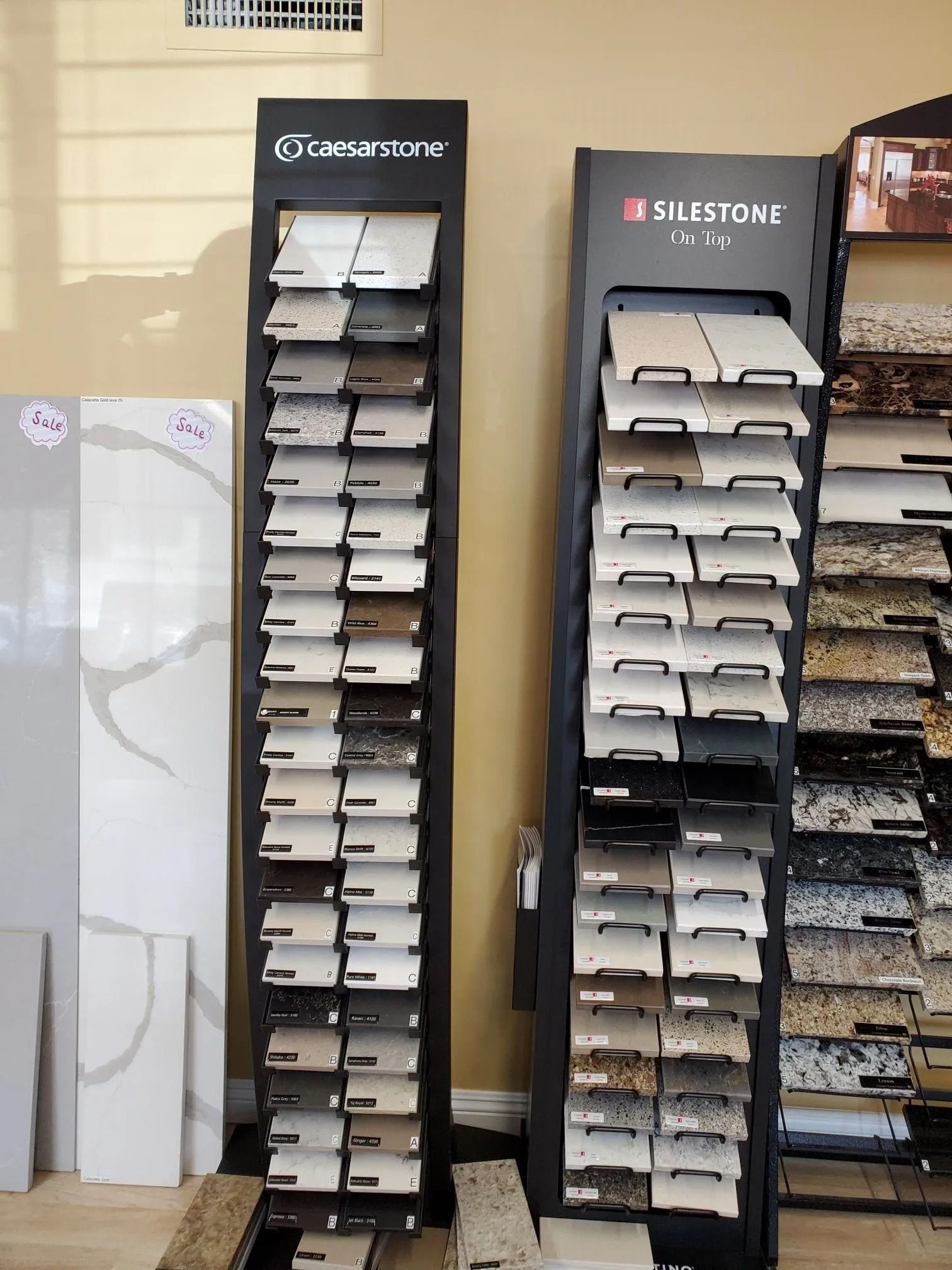 Two display stands filled with different types of tiles