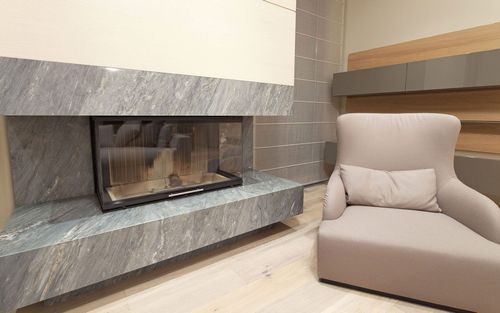 A living room with a fireplace and a chair.
