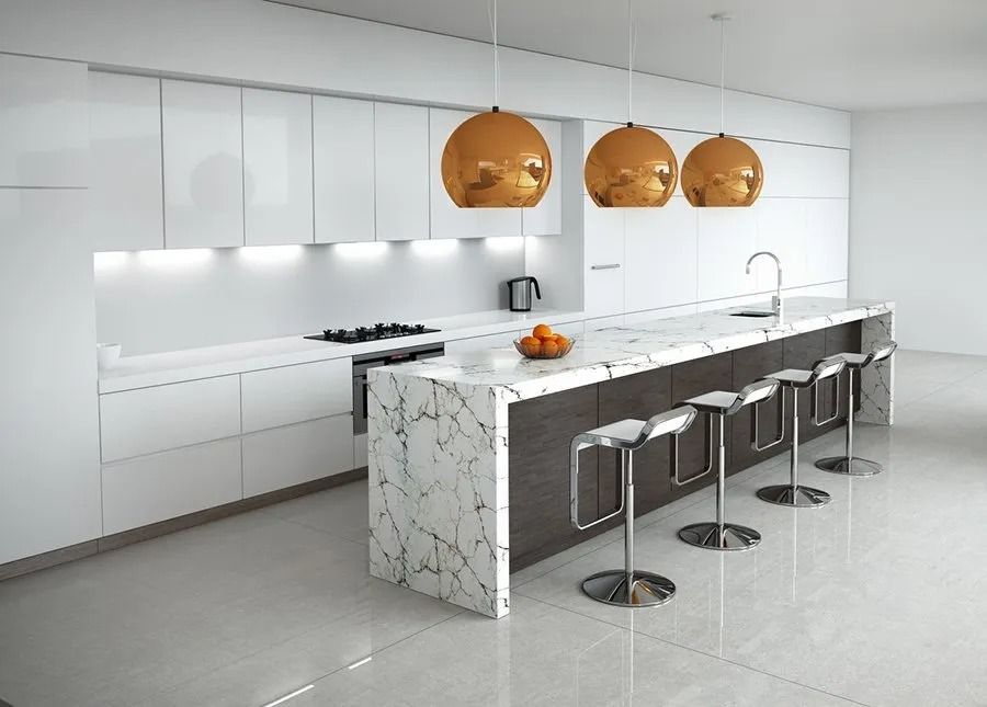 A kitchen with white cabinets and marble counter tops
