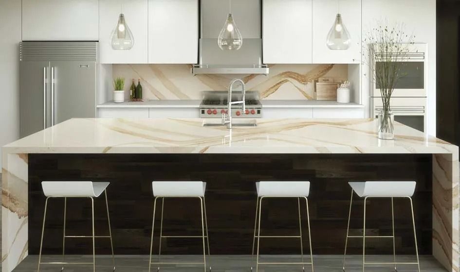 A kitchen with a large island , stools and a stove.