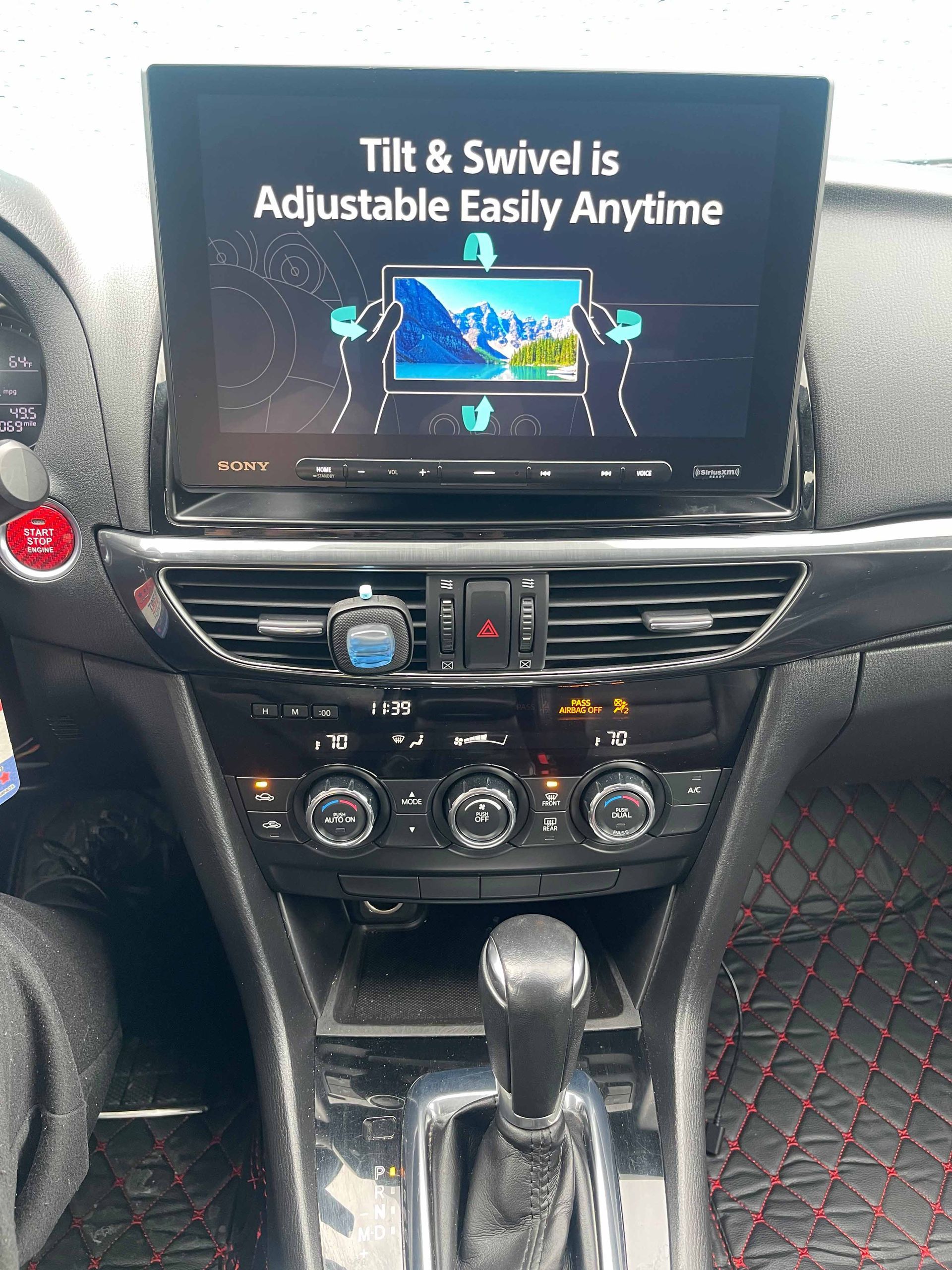 The dashboard of a car with a screen that says `` tilt & swivel is adjustable easily anytime ''.