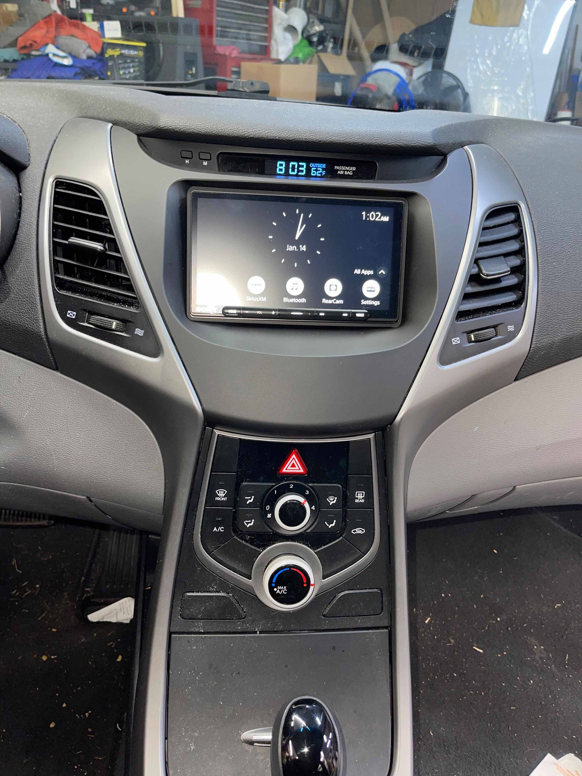 The dashboard of a car with a clock on it