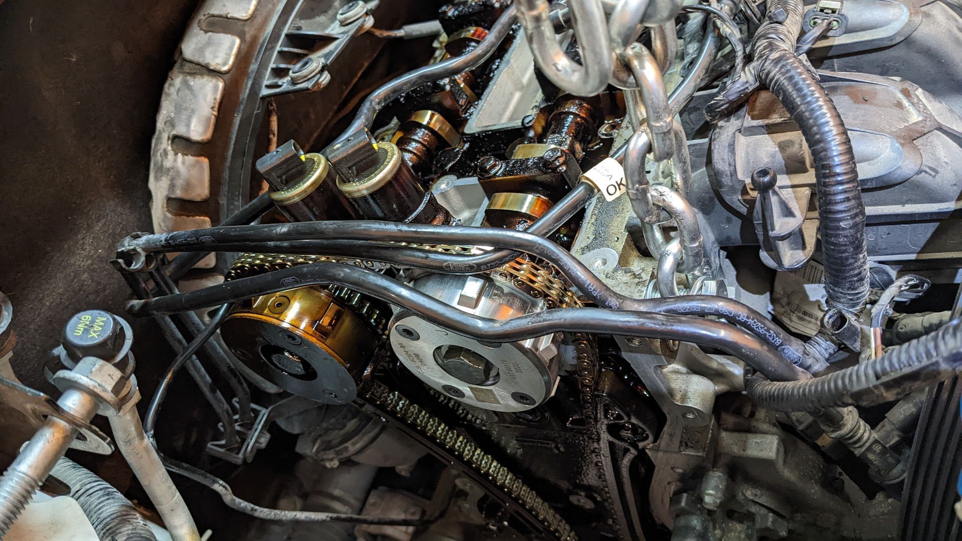 A close up of a car engine with a lot of wires coming out of it.