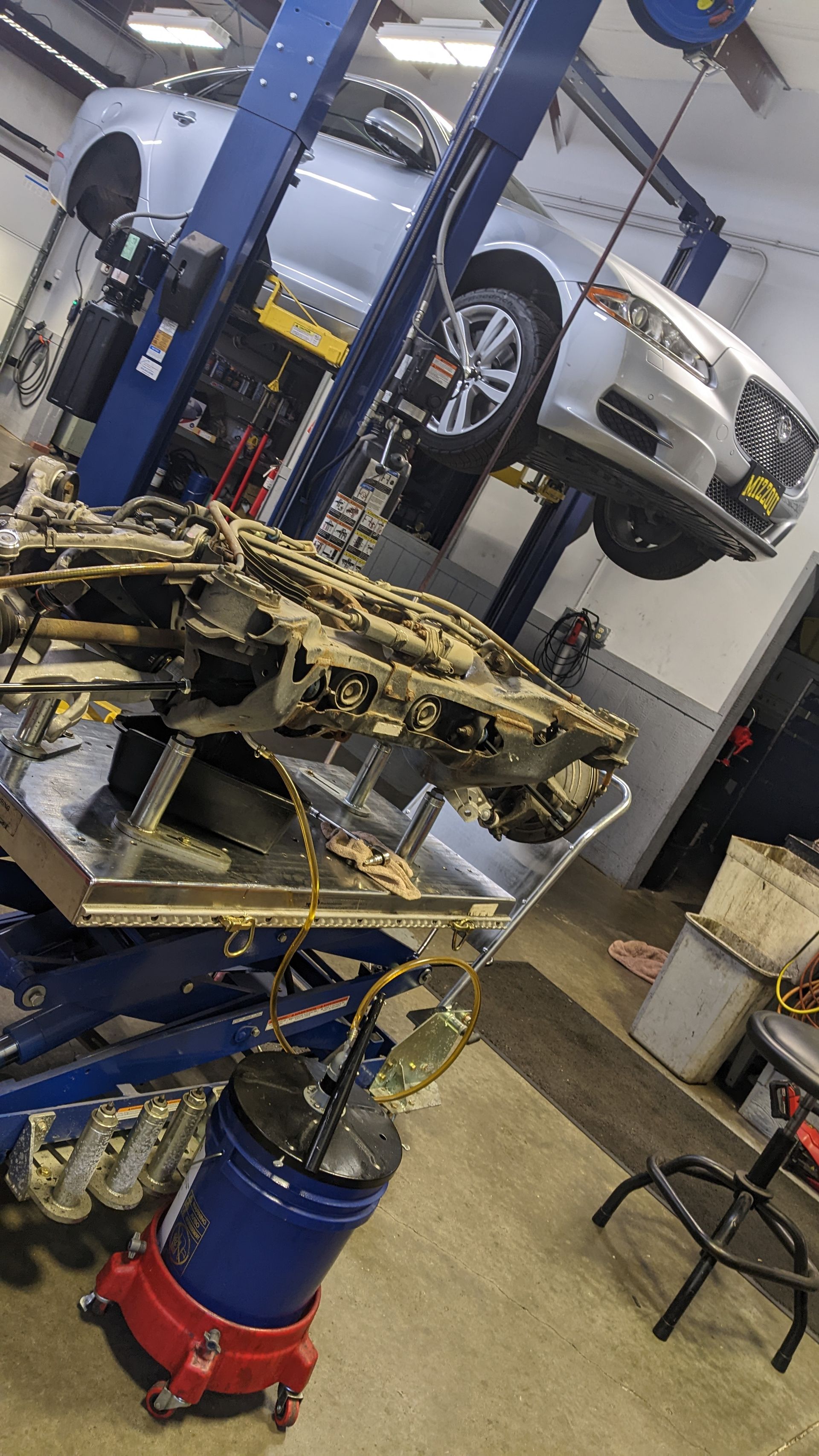 A car engine is being worked on in a garage.