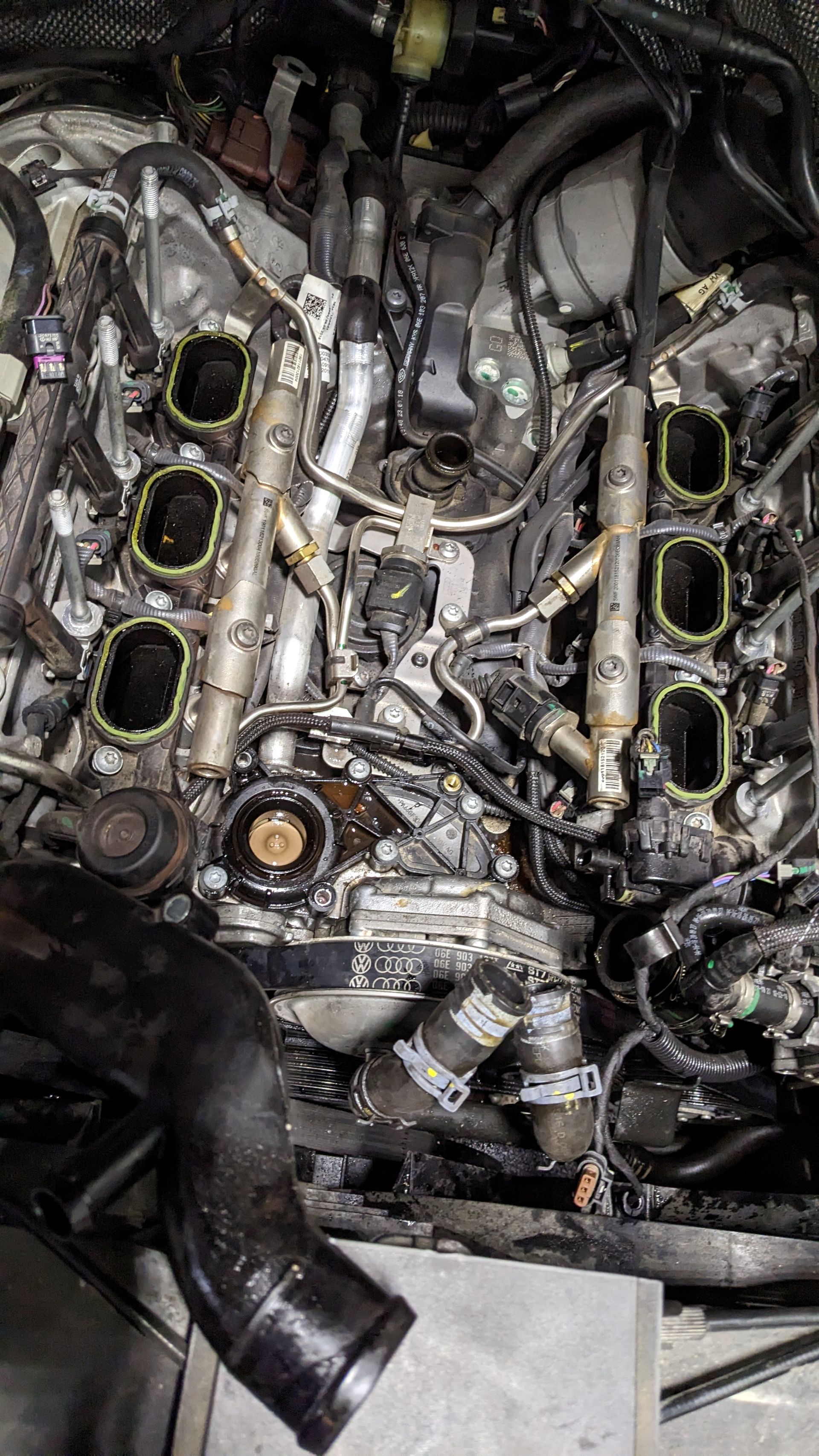A close up of a car engine with a lot of wires coming out of it.