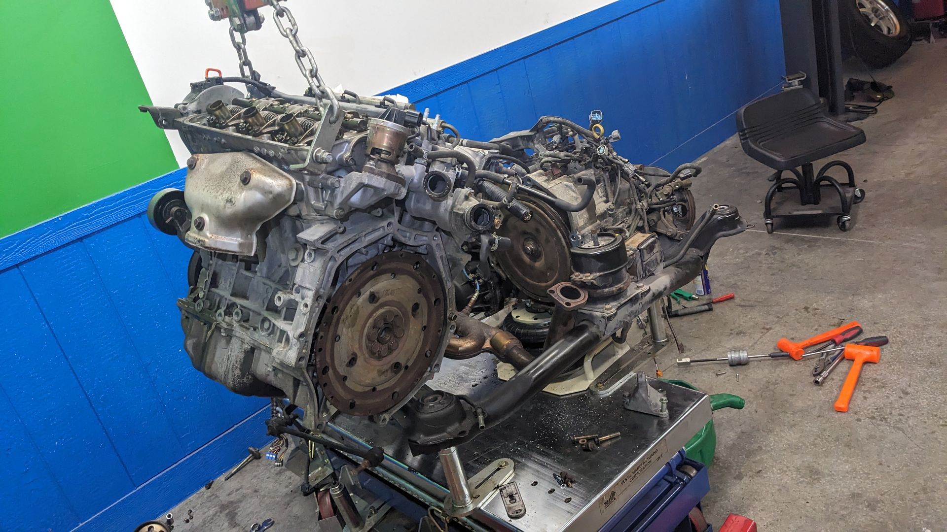 A car engine is being worked on in a garage.