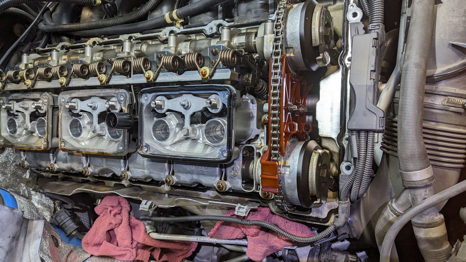 A close up of a car engine being worked on.