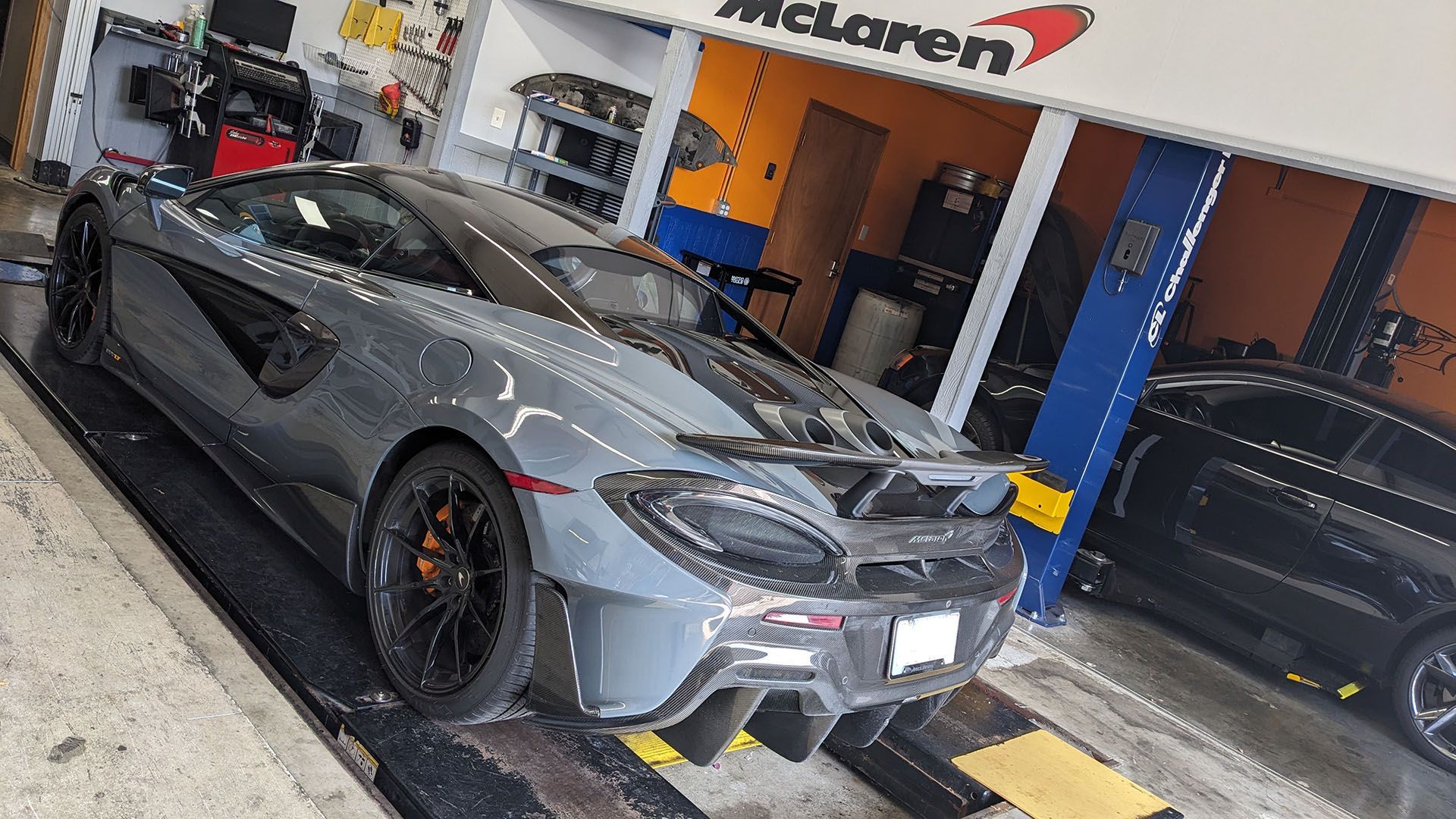 A mclaren sports car is parked in a garage.