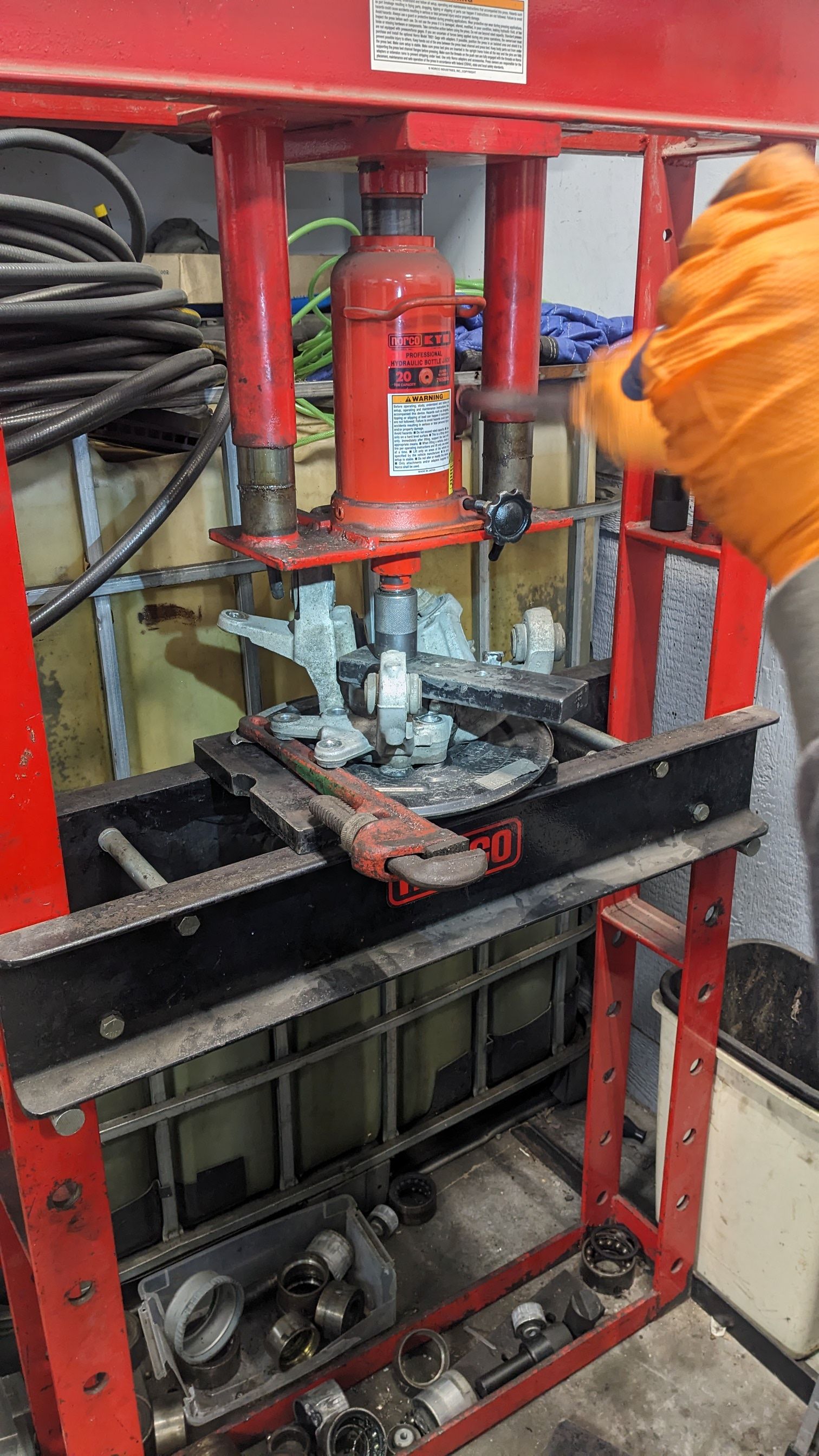 A person is working on a machine in a garage.