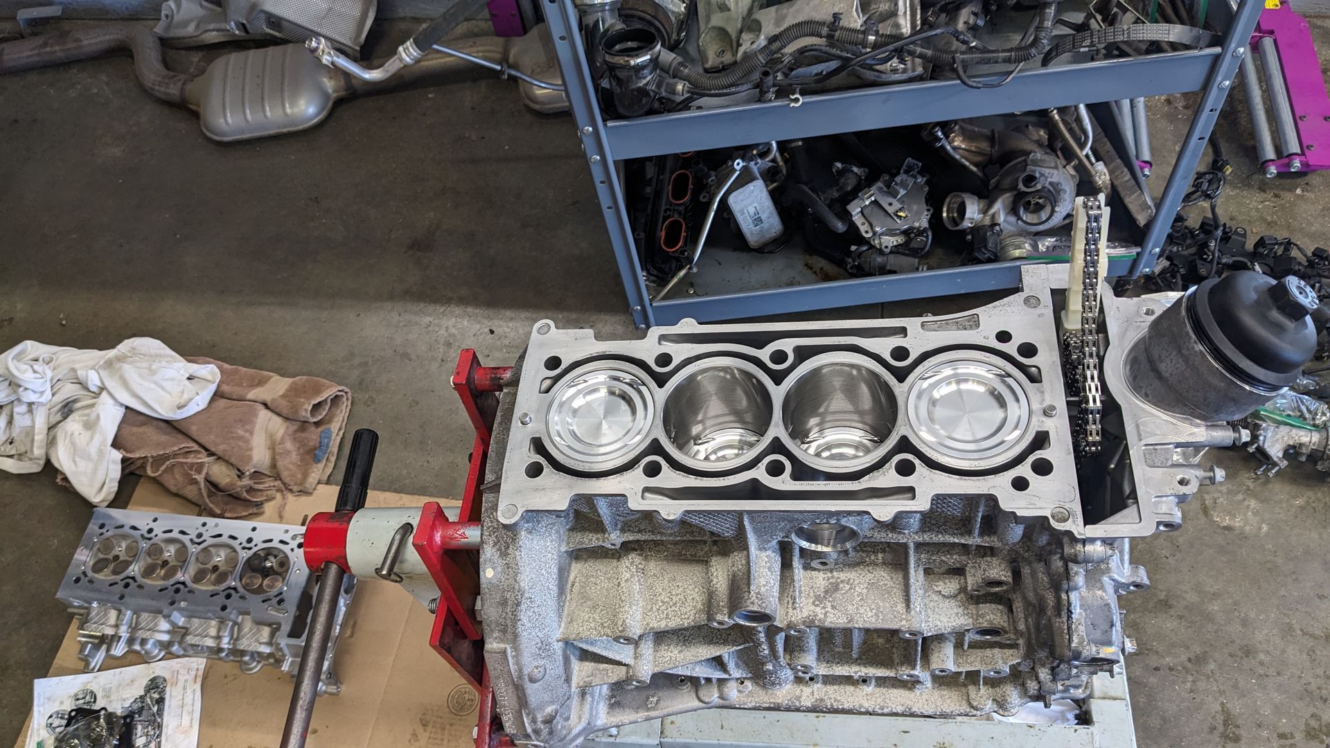 A car engine is being worked on in a garage.