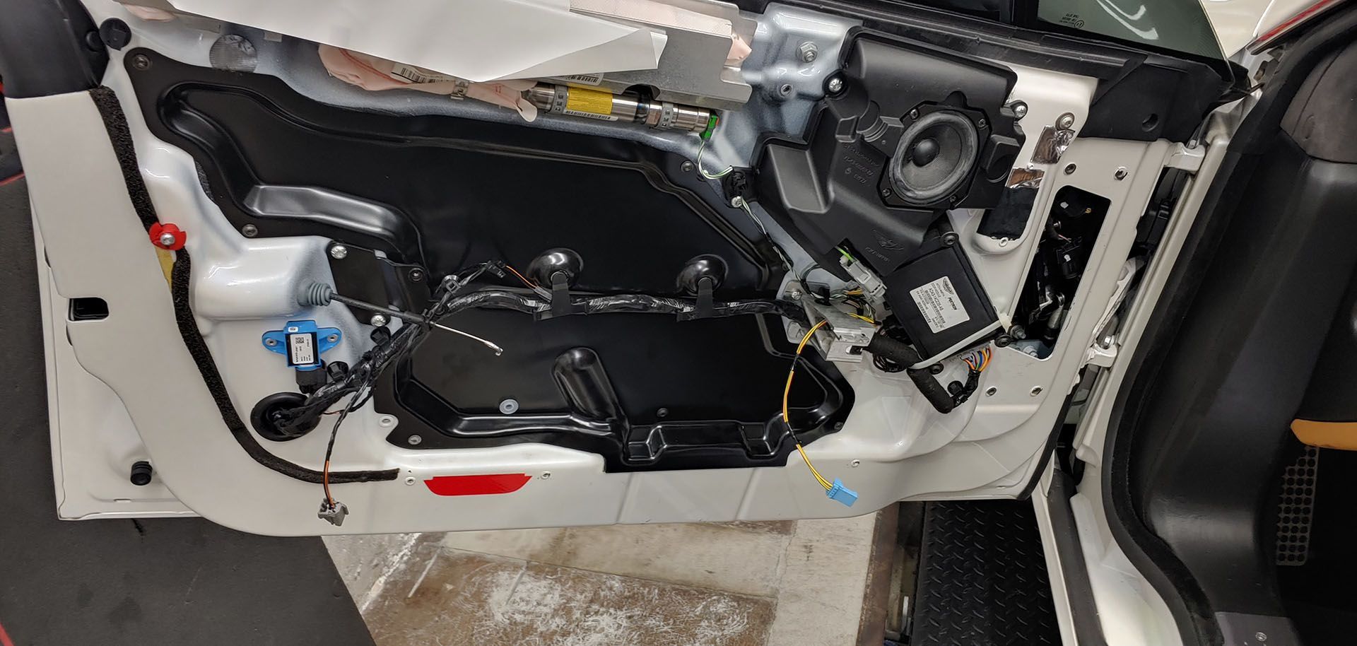 A close up of a car door with a speaker in it.