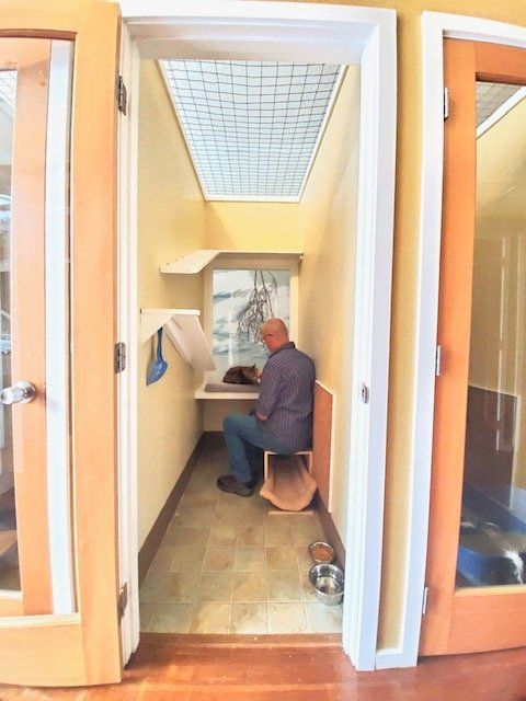 A man is sitting at a desk in a small room